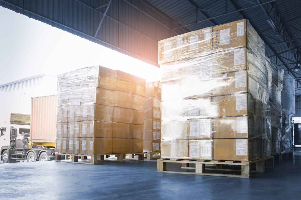 Stacked of Package Boxes Loading into Container Truck. Truck Parked Loading at Dock Warehouse. Delivery Service. Shipping Warehouse Logistics. Shipment Freight Truck Transportation.