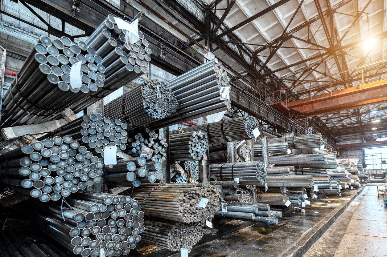 Rolled metal warehouse. Many packs of metal bars on the shelves